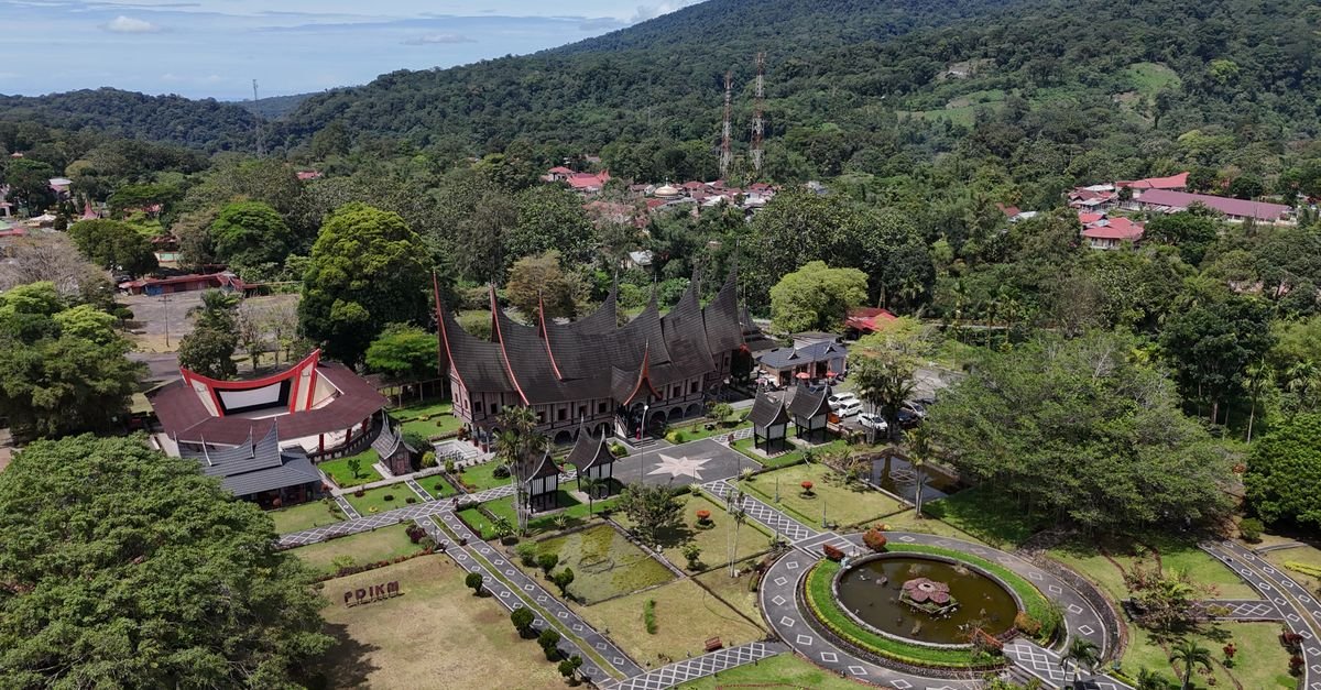Stunning aerial shot of Minangkabau architecture in the lush landscape of West Sumatra, Indonesia.